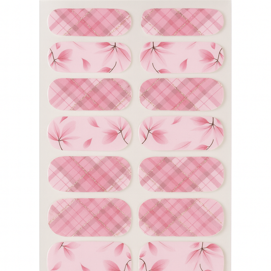 Sheet of pink plaid and floral patterned nail wraps on a white background by Stellia Beauty