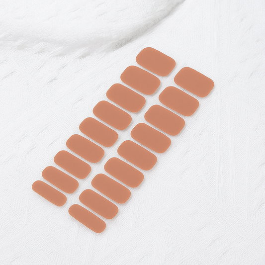 Set of nude gel nail wraps on a white textured surface by Stellia Beauty