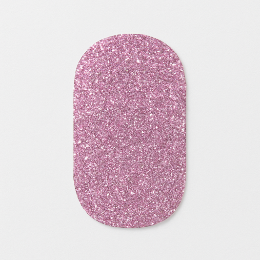 Pink glittery nail wrap on a light grey background by Stellia Beauty