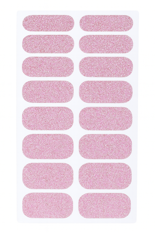 Sheet of pink glittery nail wraps on a white background by Stellia Beauty
