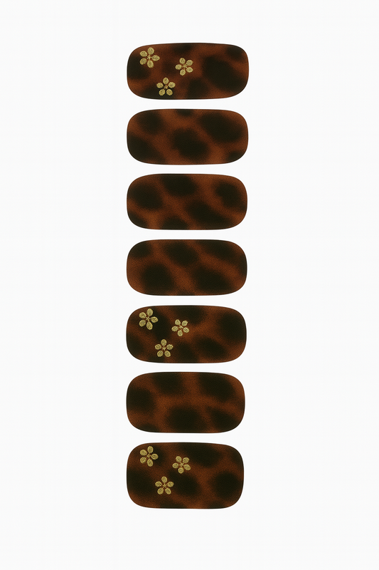 Set of tortoiseshell nail wraps with floral designs on a white background by Stellia Beauty