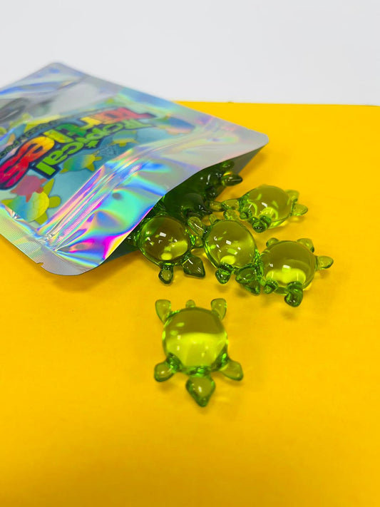 Open package of Tropical_Turtles_-_10_Pack_Kiwi_Scented_Bath_Pearls_Stellia_Beauty on yellow and white background