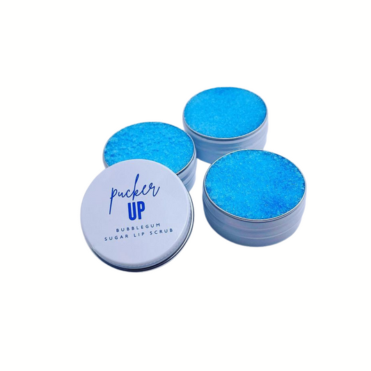 Blue lip scrub with 'pucker up' packaging on a white background by Stellia Beauty