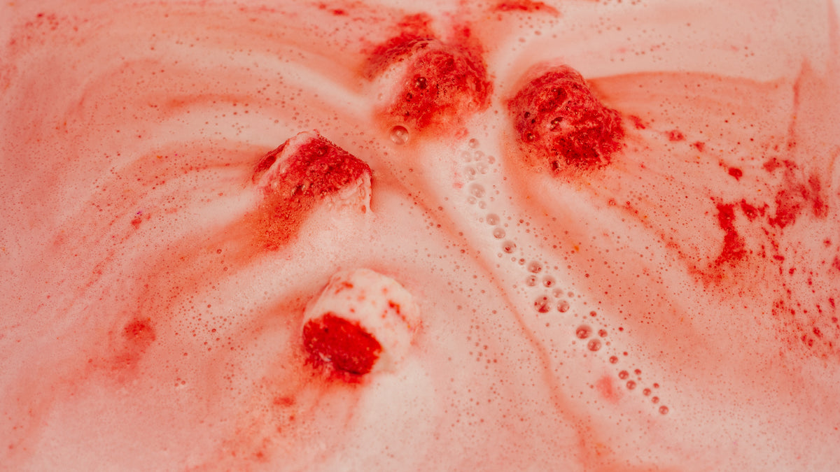 Close-up of red and white candy cane bath bombs in water Stellia Beauty