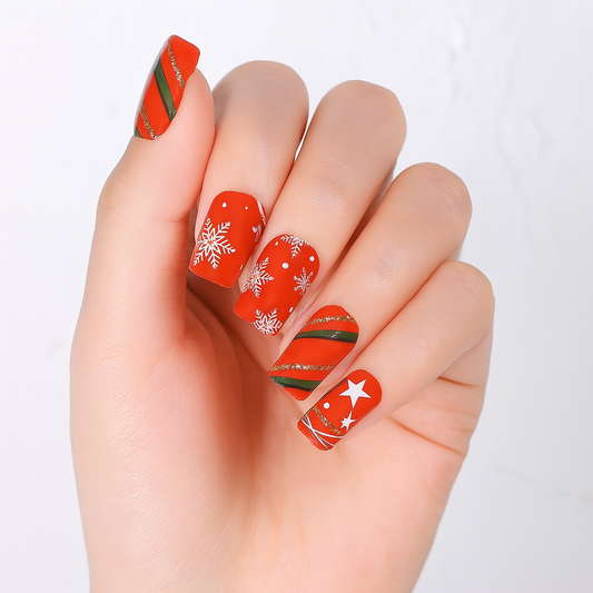Hand with red and green nail wraps on a white background by Stellia Beauty