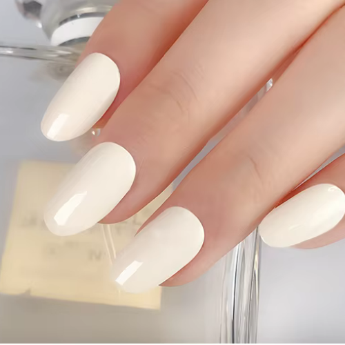 Close-up of creamy white nail wraps with a high-gloss finish on manicured hand – elegant and minimalist look