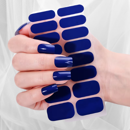Glossy deep navy blue nail wraps on hand – peel-and-stick gel-effect manicure set