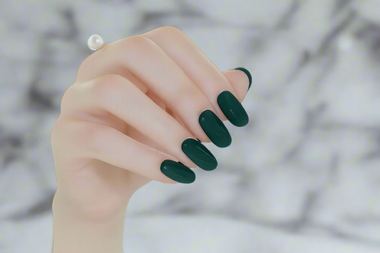 Hand with emerald green nail wraps on a white background by Stellia Beauty