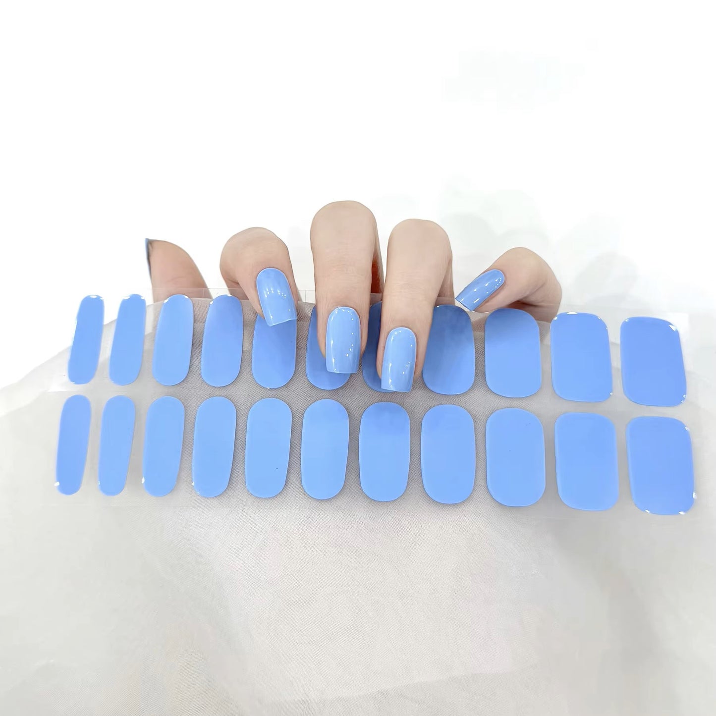 Glossy blue gel nail wraps manicure by Stellia Beauty