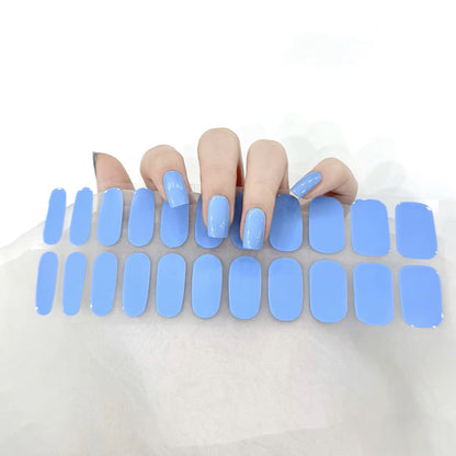 Glossy blue gel nail wraps manicure by Stellia Beauty
