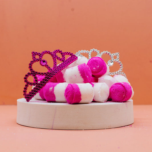 Ice Queen Mini Bath Bombs Pink and white striped bath bombs with decorative crowns on a peach background by Stellia Beauty