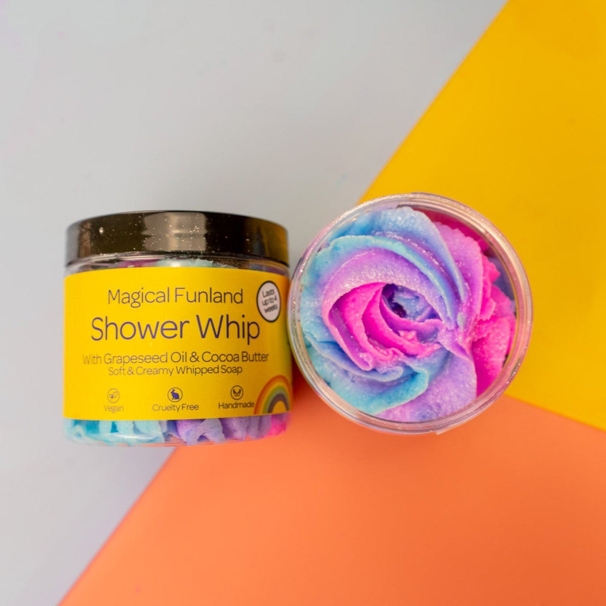 Magical Funland Shower Whip with colorful rose-shaped product on a yellow and orange background by Stellia Beauty