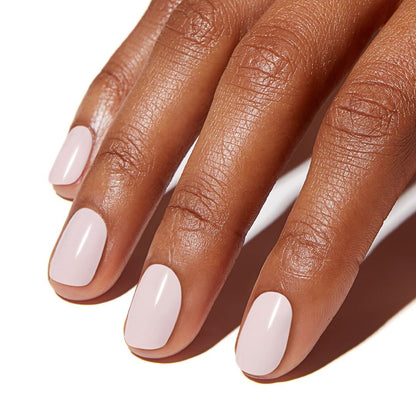 Close-up of a hand with light pink nail polish on a white background CND_Vinylux_Long_Wear_Polish_Winter_Glow_by_Stellia_Beauty