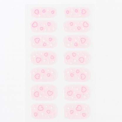 Pattern of pink hearts gel nail wraps on a light pink background by Stellia Beauty