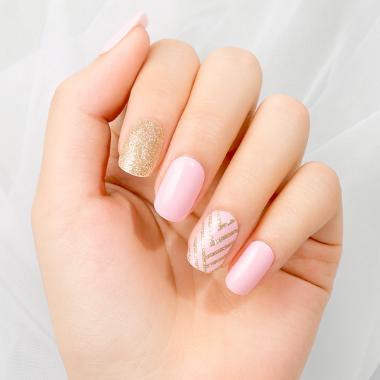 Hand showing Stellia Beauty pink and gold nail wraps