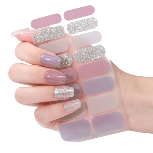 Hand displaying taupe and silver glitter nail wraps with coordinating wrap sheet – elegant manicure style