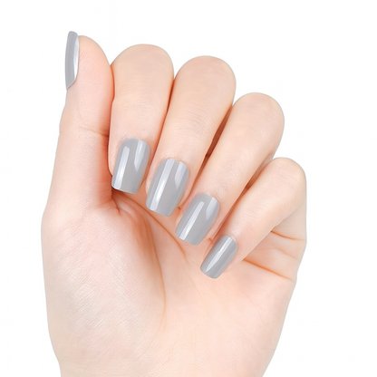 Hand with taupe semi cured gel nail wraps on a white background by Stellia Beauty