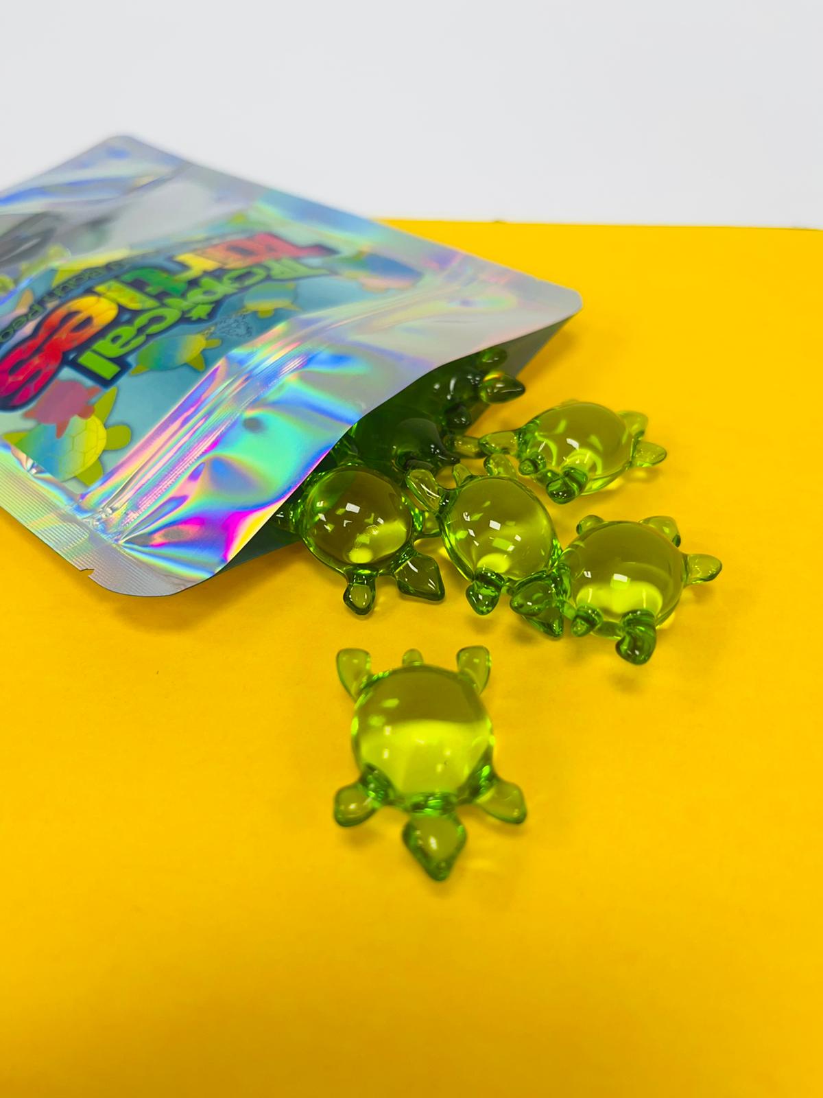 Open package of Tropical_Turtles_-_10_Pack_Kiwi_Scented_Bath_Pearls_Stellia_Beauty on yellow and white background