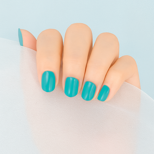 Hand with turquoise gel nail wraps on a light blue background by Stellia Beauty