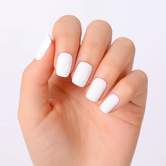 Hand with white gel nail wraps on a light grey background by Stellia Beauty