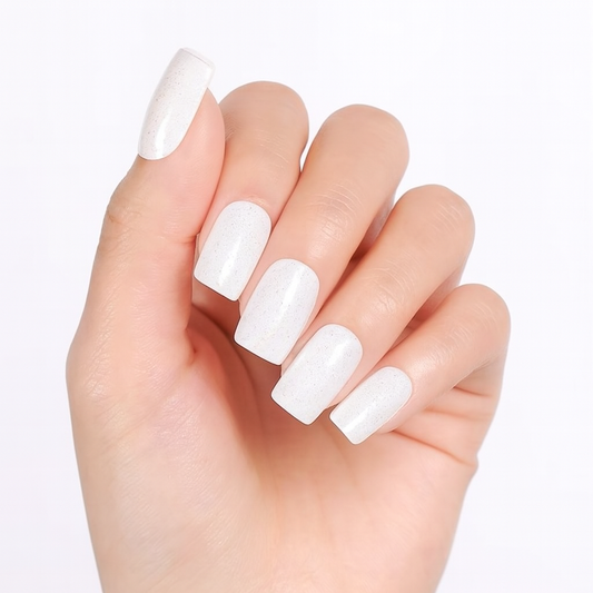 Hand with white shimmer gel nail wraps on a light background by Stellia Beauty