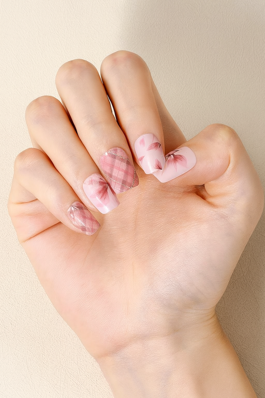 Hand with pink nail wraps on a beige background by Stellia Beauty