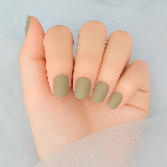 Hand with green matte gel nail wraps on a light grey background by Stellia Beauty