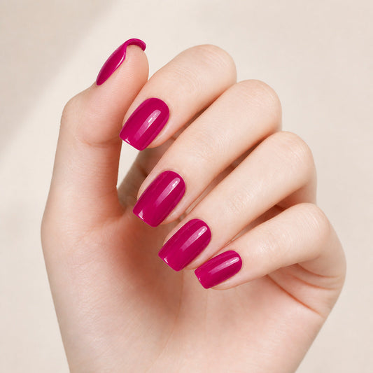 Hand wearing raspberry pink nail wraps with a glossy finish by Stellia Beauty
