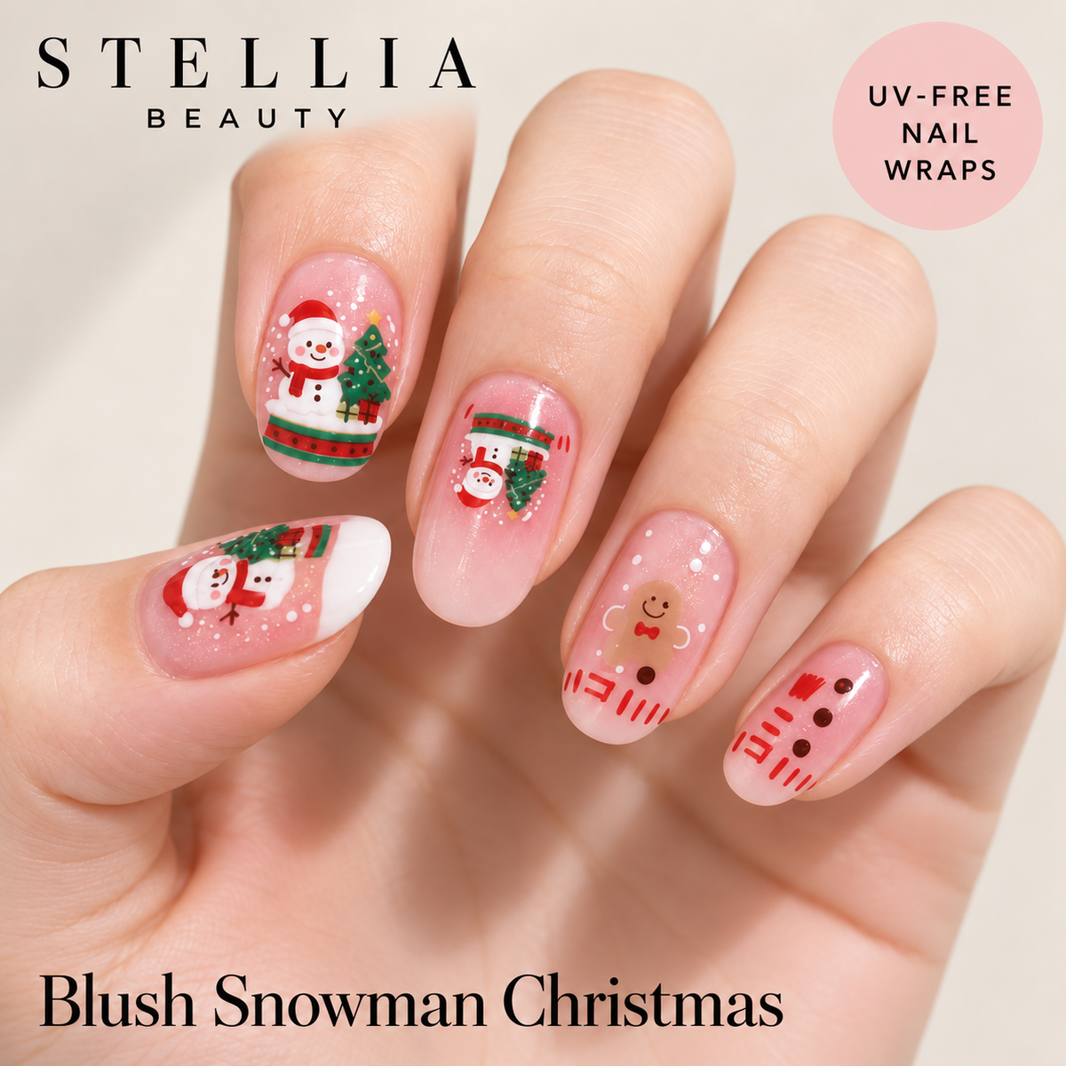Stellia Beauty Blush Snowman Christmas nail wraps on manicured hands with pink snowmen and festive accents.