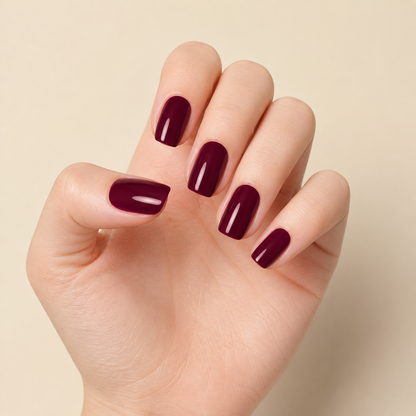 Stellia Beauty Burgundy Wine nail wraps on a glossy deep burgundy manicure
