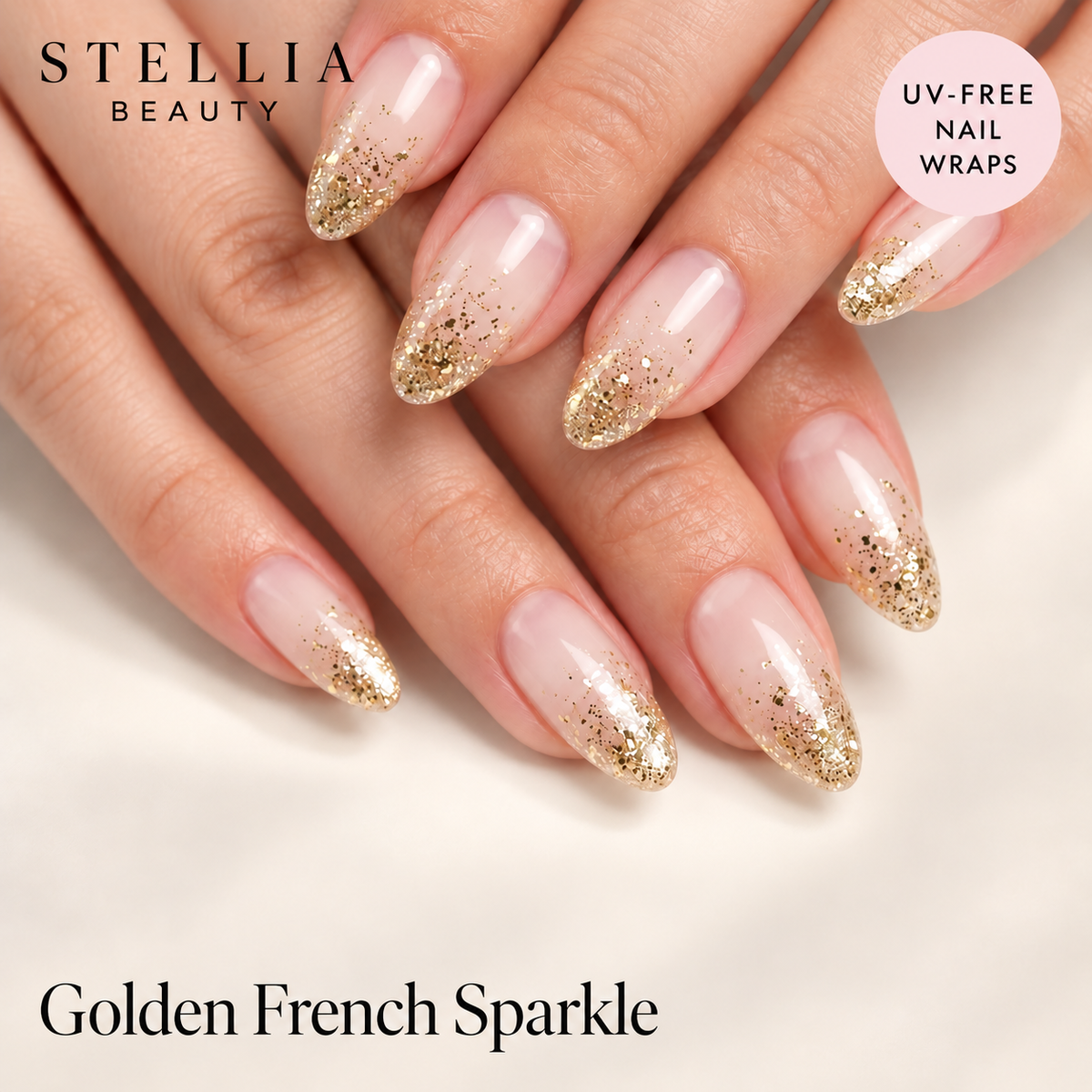 Stellia Beauty Golden French Sparkle nail wraps on manicured hands with gold glitter tips.