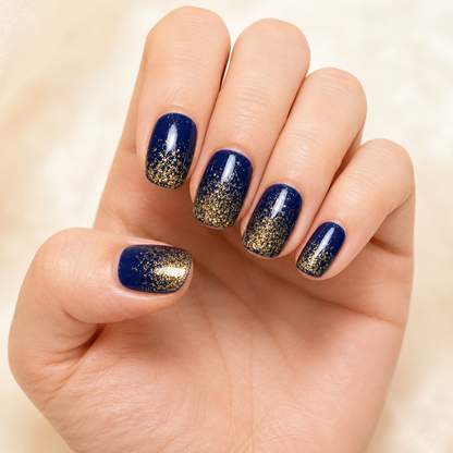 Stellia Beauty Midnight Gold Glitter nail wraps on a navy blue with a gold glitter gradient manicure