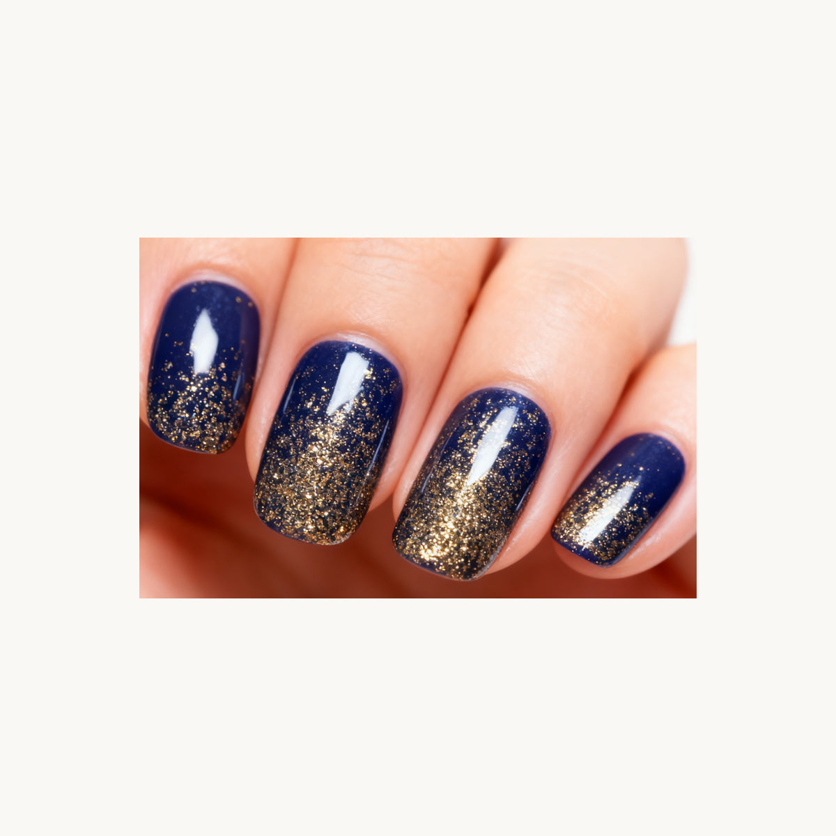Stellia Beauty Midnight Gold Glitter nail wraps in a second navy blue with a gold glitter gradient manicure view